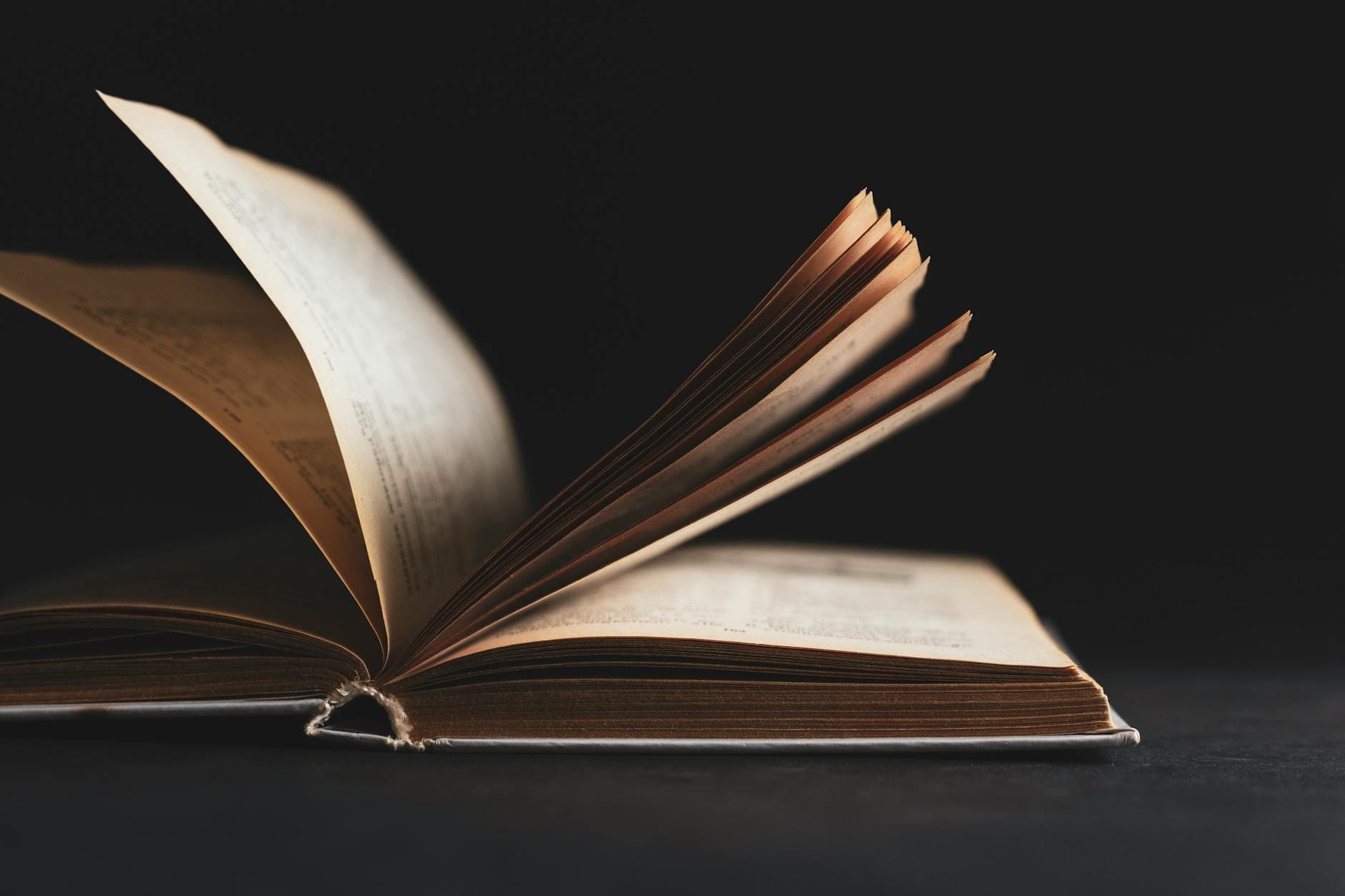 An open book with pages turning