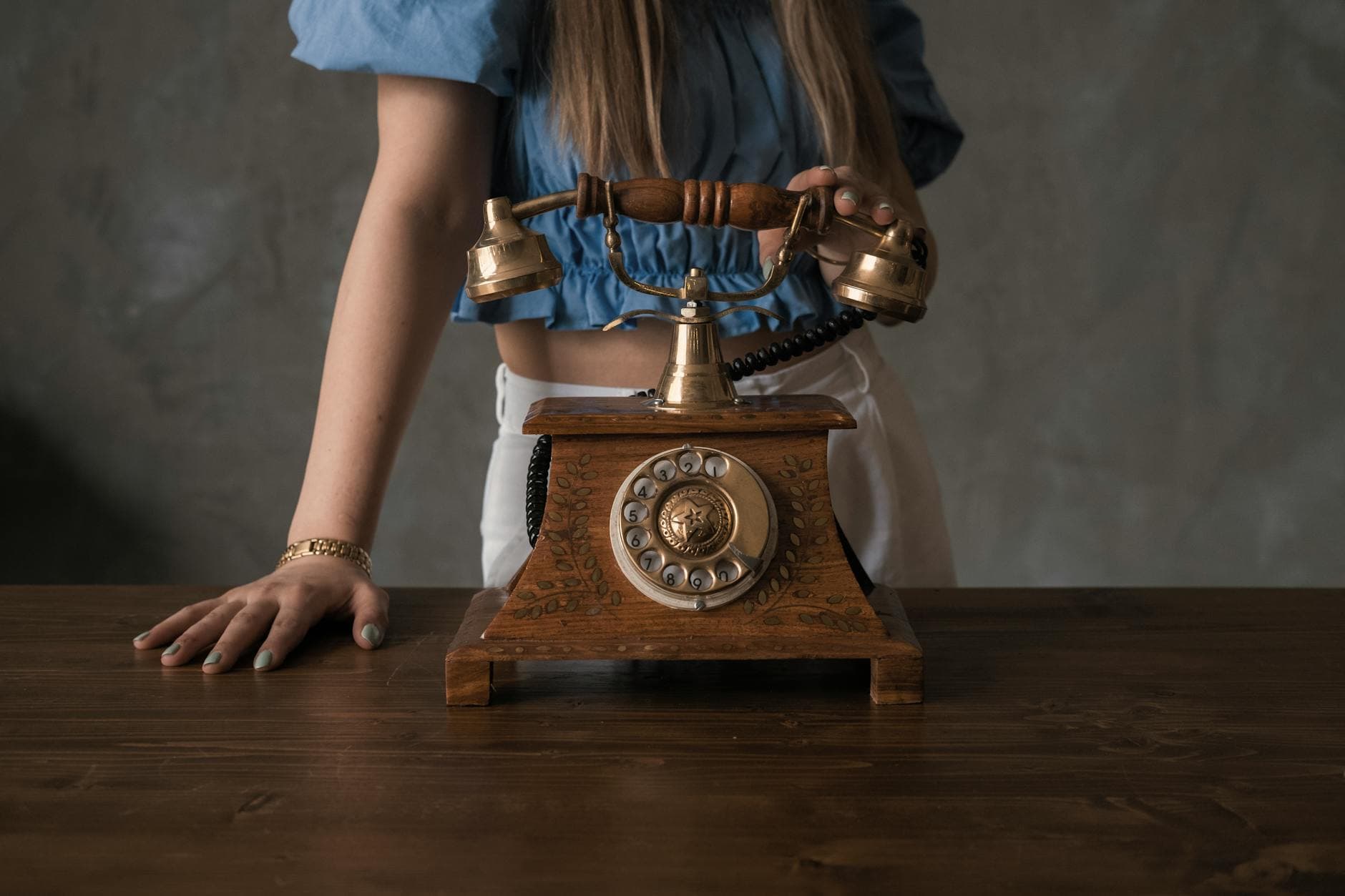A vintage telephone on a wooden desk